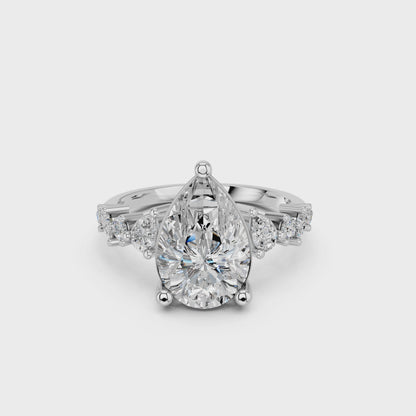 PEAR ENGAGEMENT RING WITH SIDE STONE